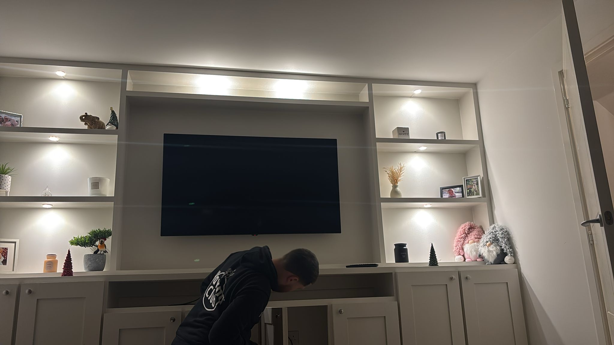 Fitted media wall with shelving and lighting